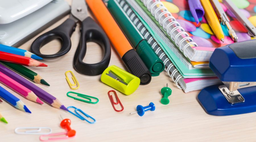 Colorful stationery items are scattered on a desk, ideal for studying or artwork.